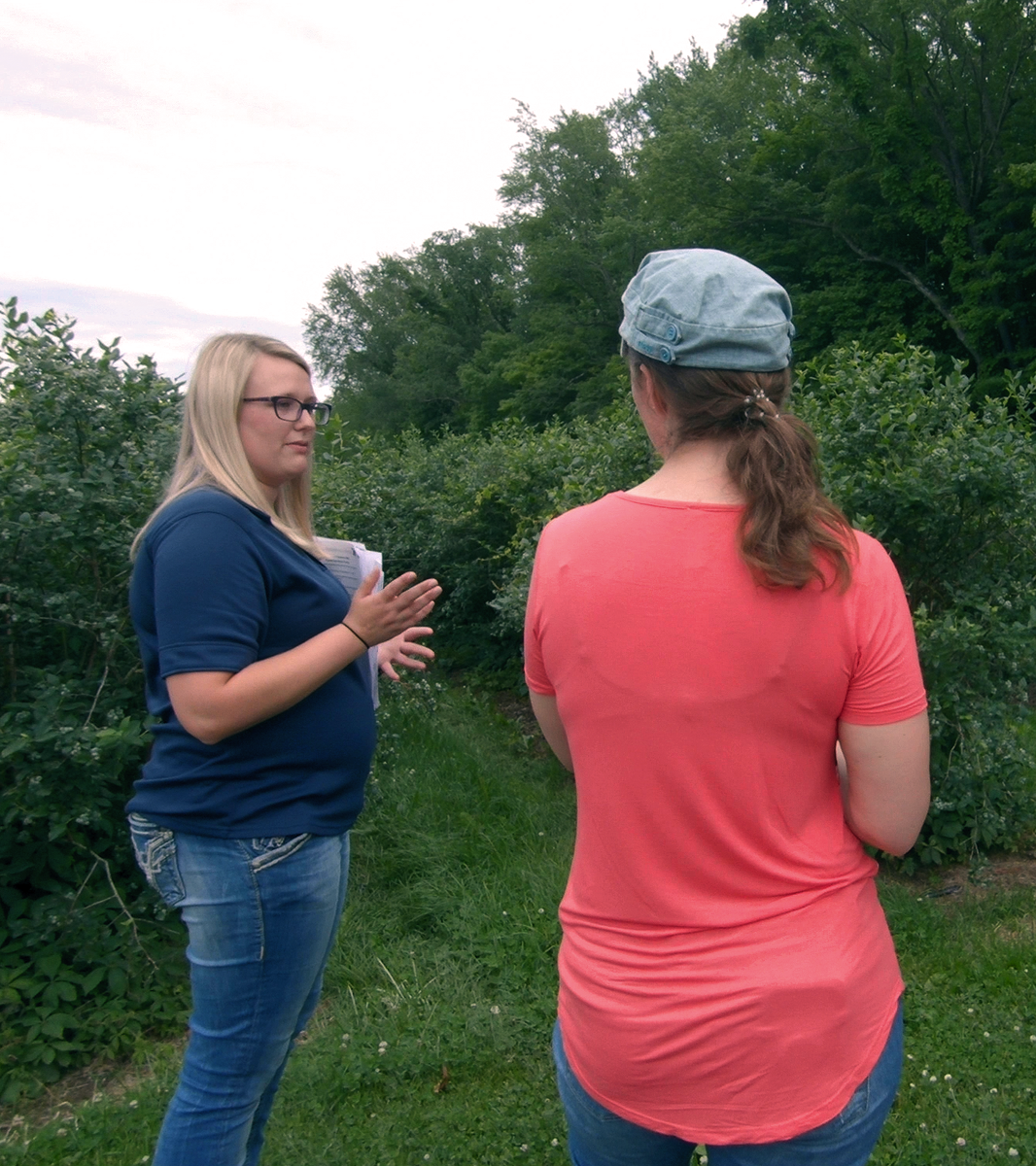 A grower and a Produce Safety Technician talking to each other